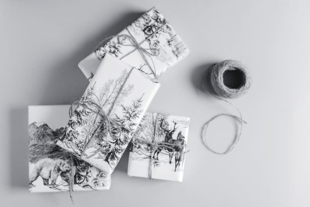 Wrapped gifts arranged on a plain surface in neutral tones
